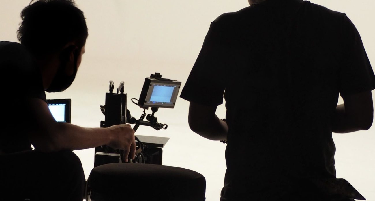 Behind the scenes of silhouette working people that making movie or tv channel content or film in big studio with camera set and production crew team.