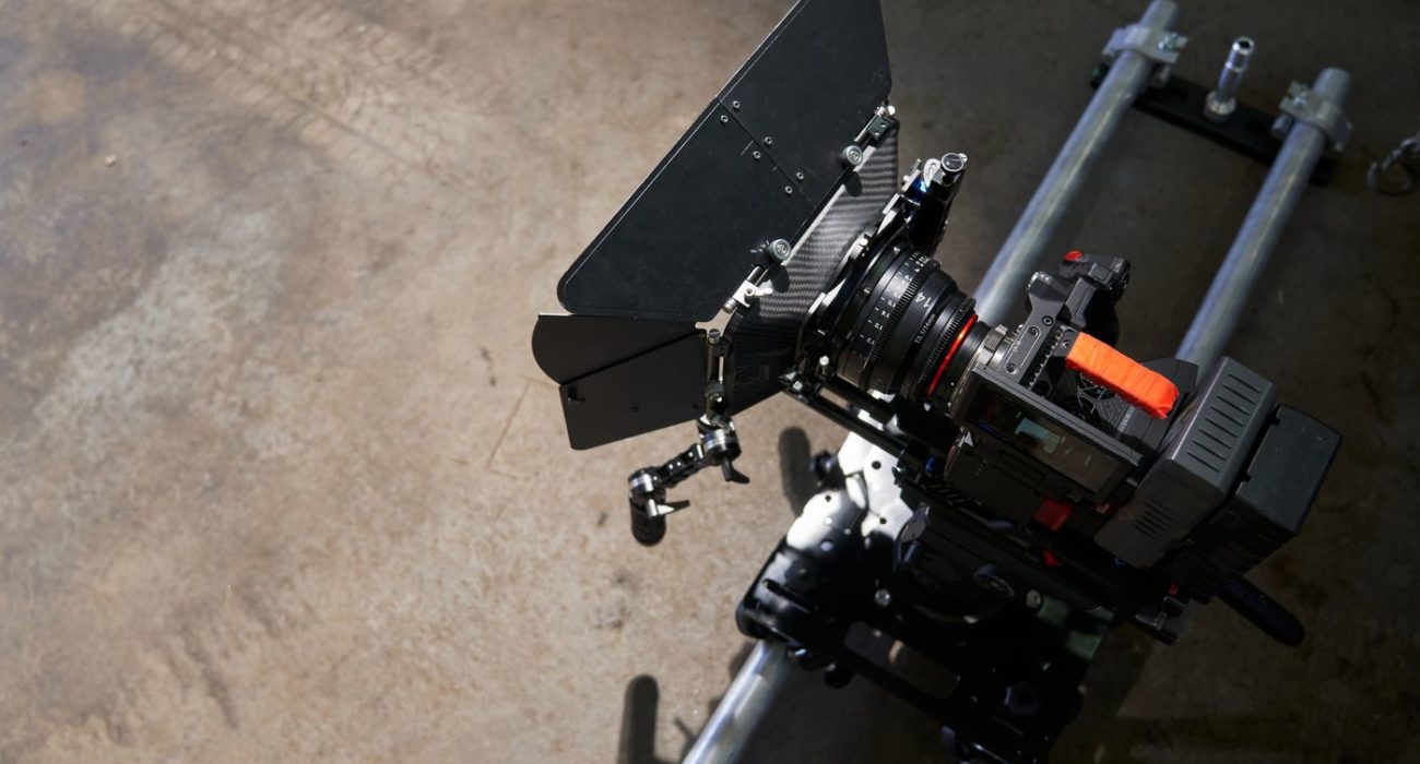 on the camera trolley and rails there is a professional movie camera with a full body kit. camcorder before filming. High quality photo